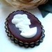the maroon lady cameo brooch.