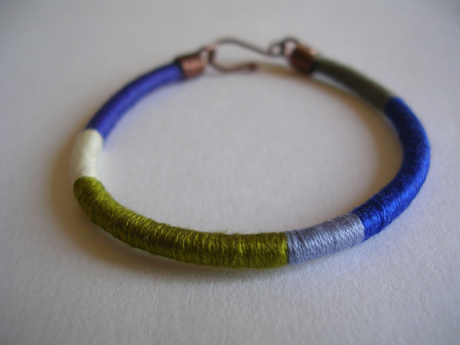 The embroiderer's bracelet: color block bracelet in cornflower blue, beige gray, olive green, lilac blue, cobalt blue and beaver gray