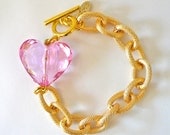 Gold link chain bracelet with pink faceted heart