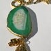 Chunky gold chain link necklace with green agate & gold charms