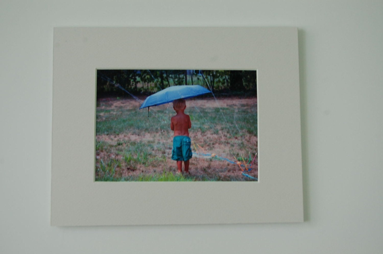 Singing in the Rain - Child holds umbrella under Sprinkler - Matted 8 x 10 Fine Art Print