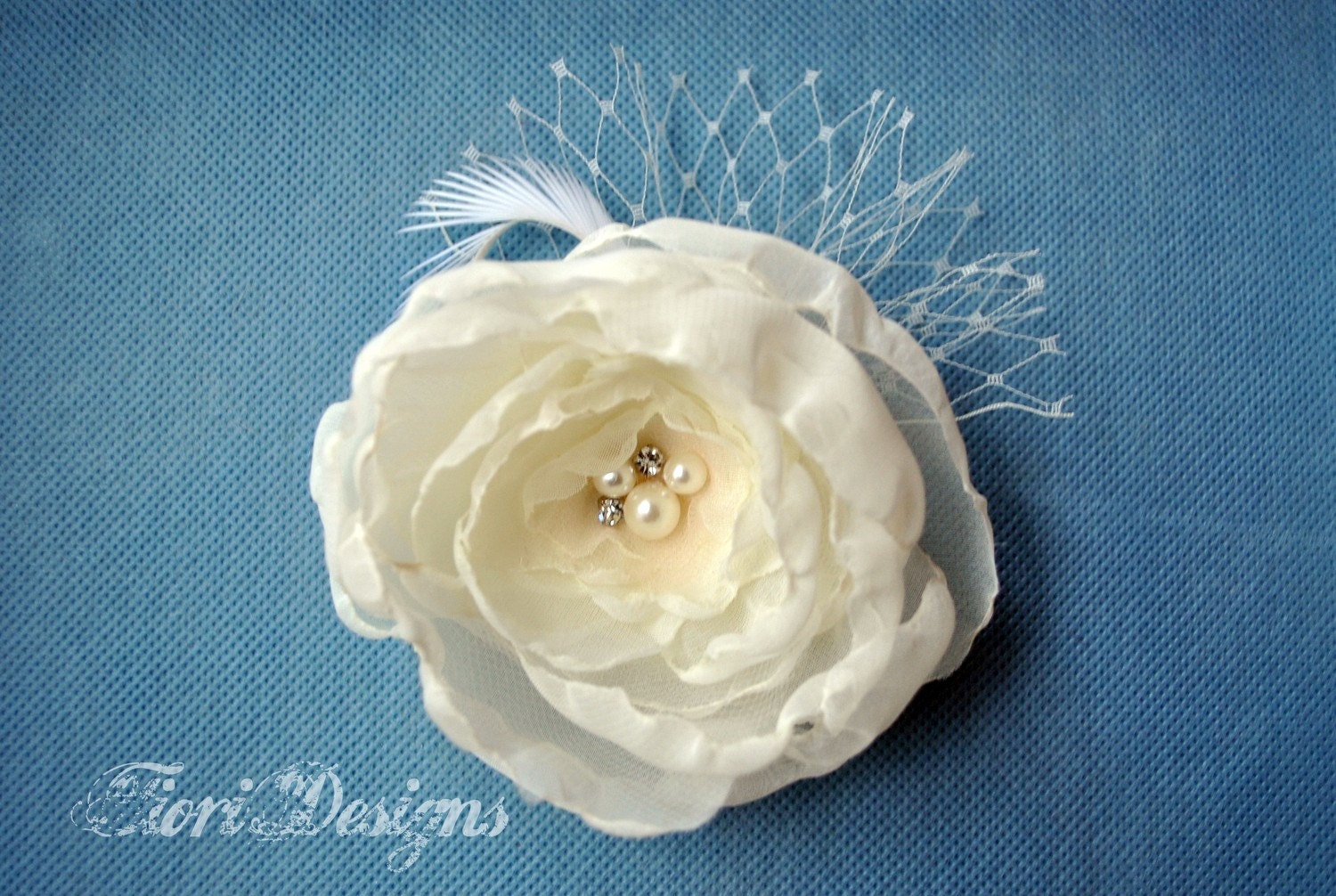 Elegant ivory flower clip/fascinator with a single feather and french netting - perfect for a bride