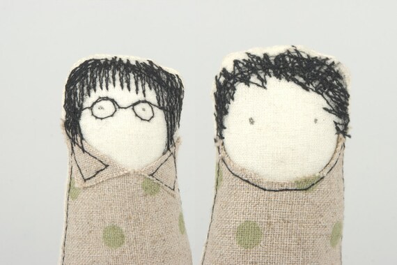 Boy and girl - little twins, she wearing glasses and a dress and he green polka-dot shirt and corduroy