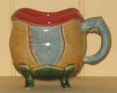 Cup in yellow, blue, green and persimmon