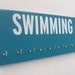 Swimming: Use a Medals Rack to display your swimming ribbons