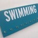 Swimming: Use a Medals Rack to display your swimming ribbons