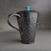 Tall Lidded Spiky Mug: Black and Caribbean Blue Dangerously Spiky Lidded Travel Mug by Symmetrical Pottery