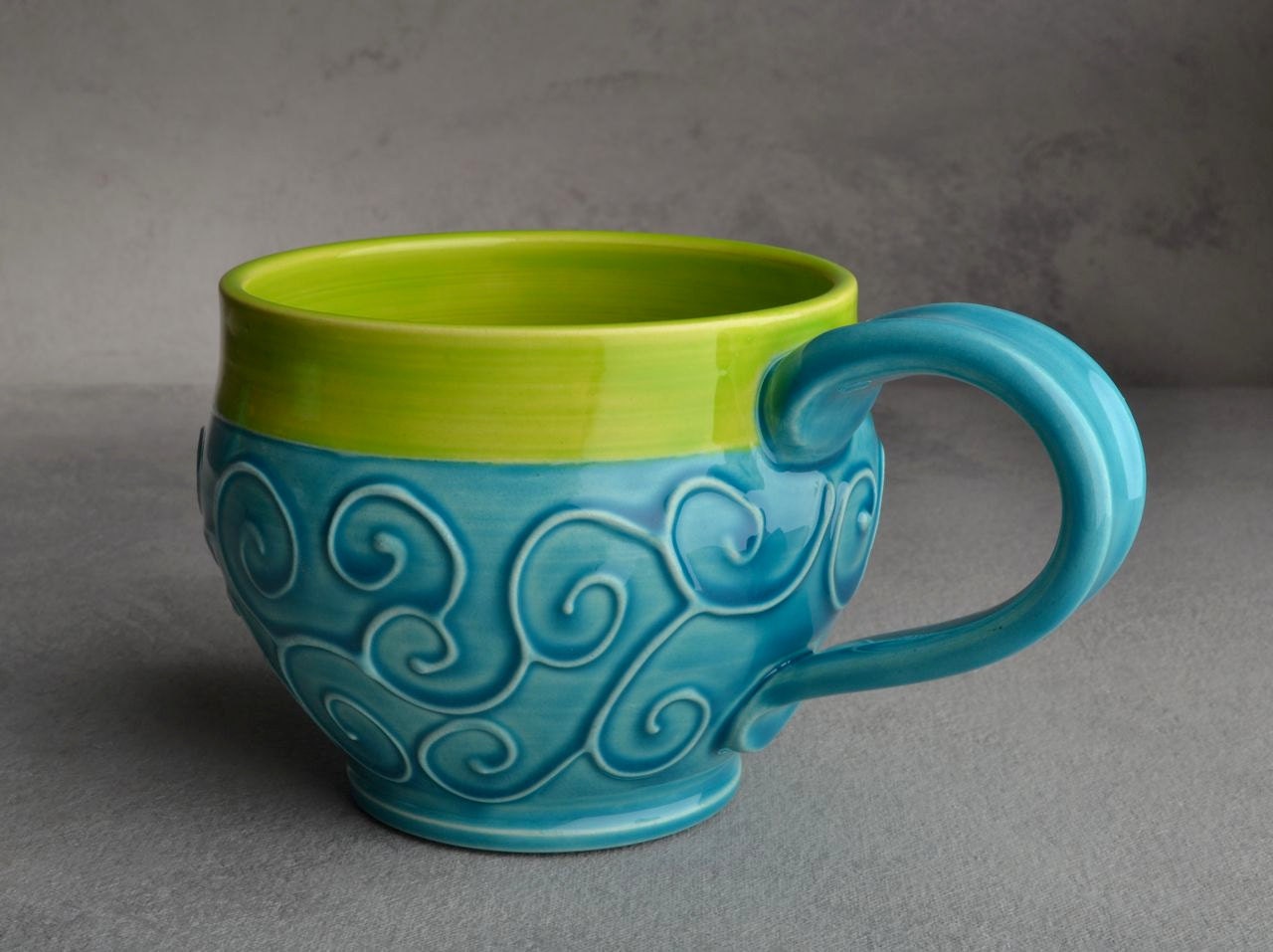 Curly Mug: Caribbean Blue and Neon Green Slip Trailed Mug by Symmetrical Pottery