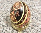 Pysanka egg with red roses and orange baskets