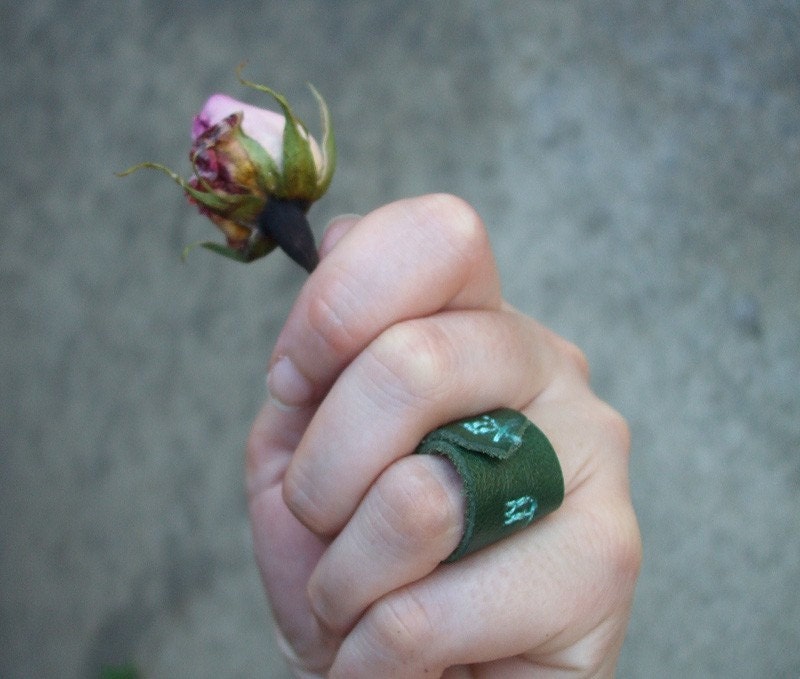 dancing. A leather ring in green and teal