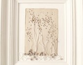 framed mixed media assemblage.  white painting.  a page from the book of go cry me a river.