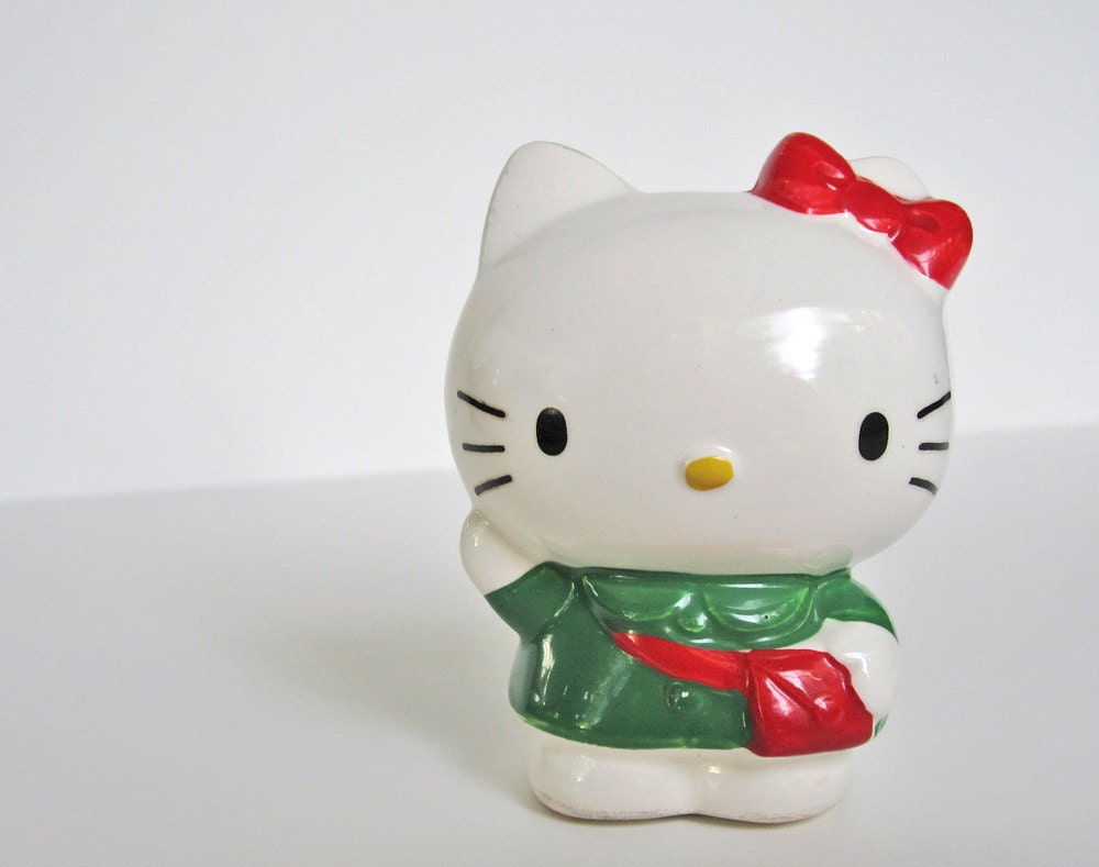 Hello Kitty coin bank, piggy bank, money box, ceramic figure, green dress, red purse, 3 inches tall, Sanrio vintage 1983