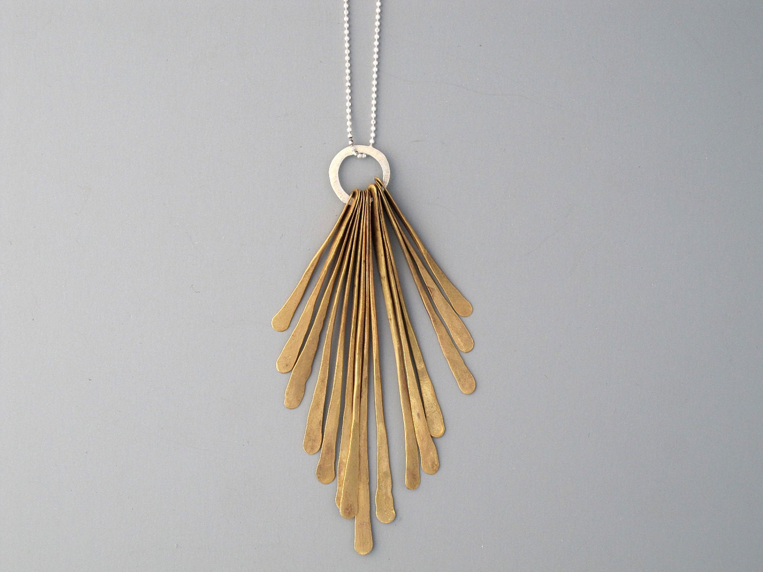 Handmade jewelry. Brass and sterling silver feather necklace.