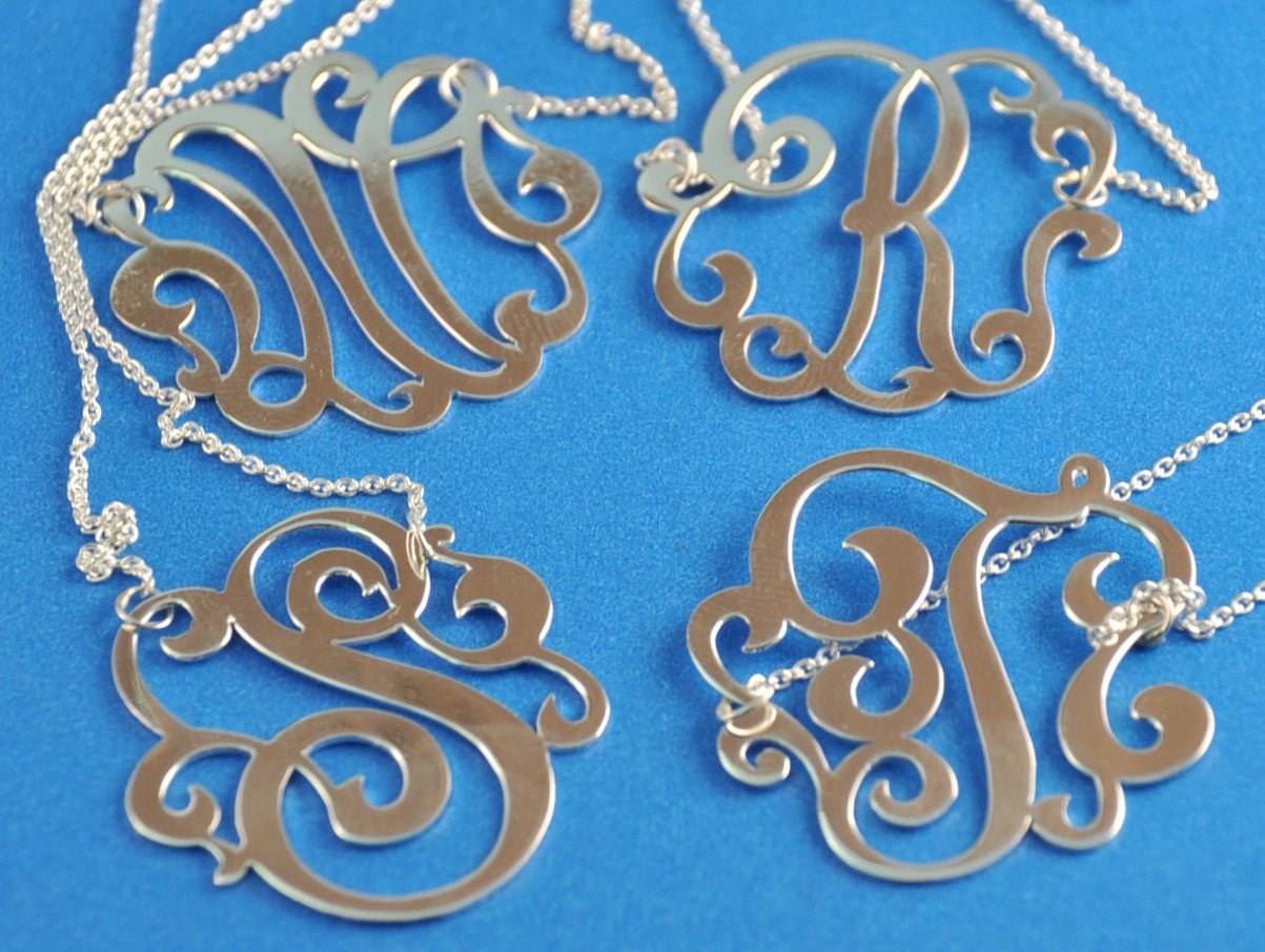 Sterling silver  initial. 1.25" size. with a  chain.
