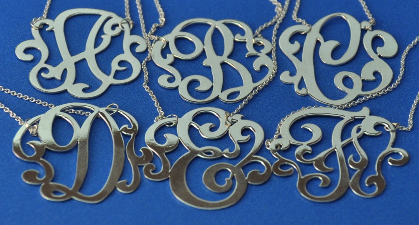 Sterling silver  initial. 1.25" size. with a  chain.