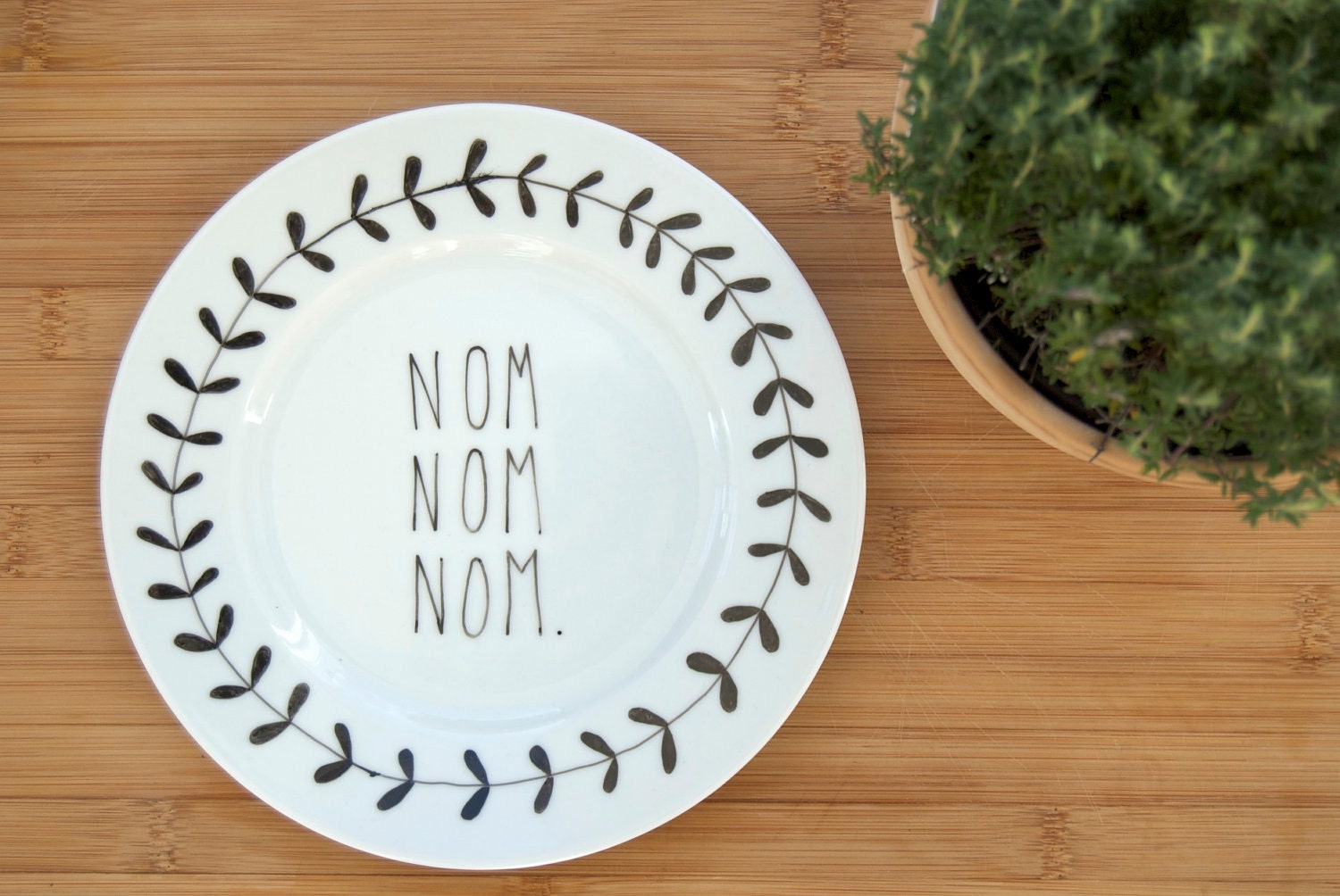 Illustrated NOM NOM NOM plate with leafy wreath