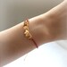 Baby Skull Bracelet -gold plated brass in red cord