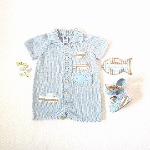 A knitted short jumpsuit in soft blue with fishes