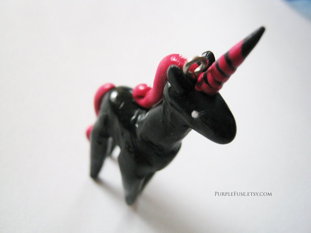 Black and red Unicorn charm figure with black cell phone strap