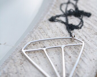 cartoon diamond necklace geometric design silver contemporary outlined diamond jewelry