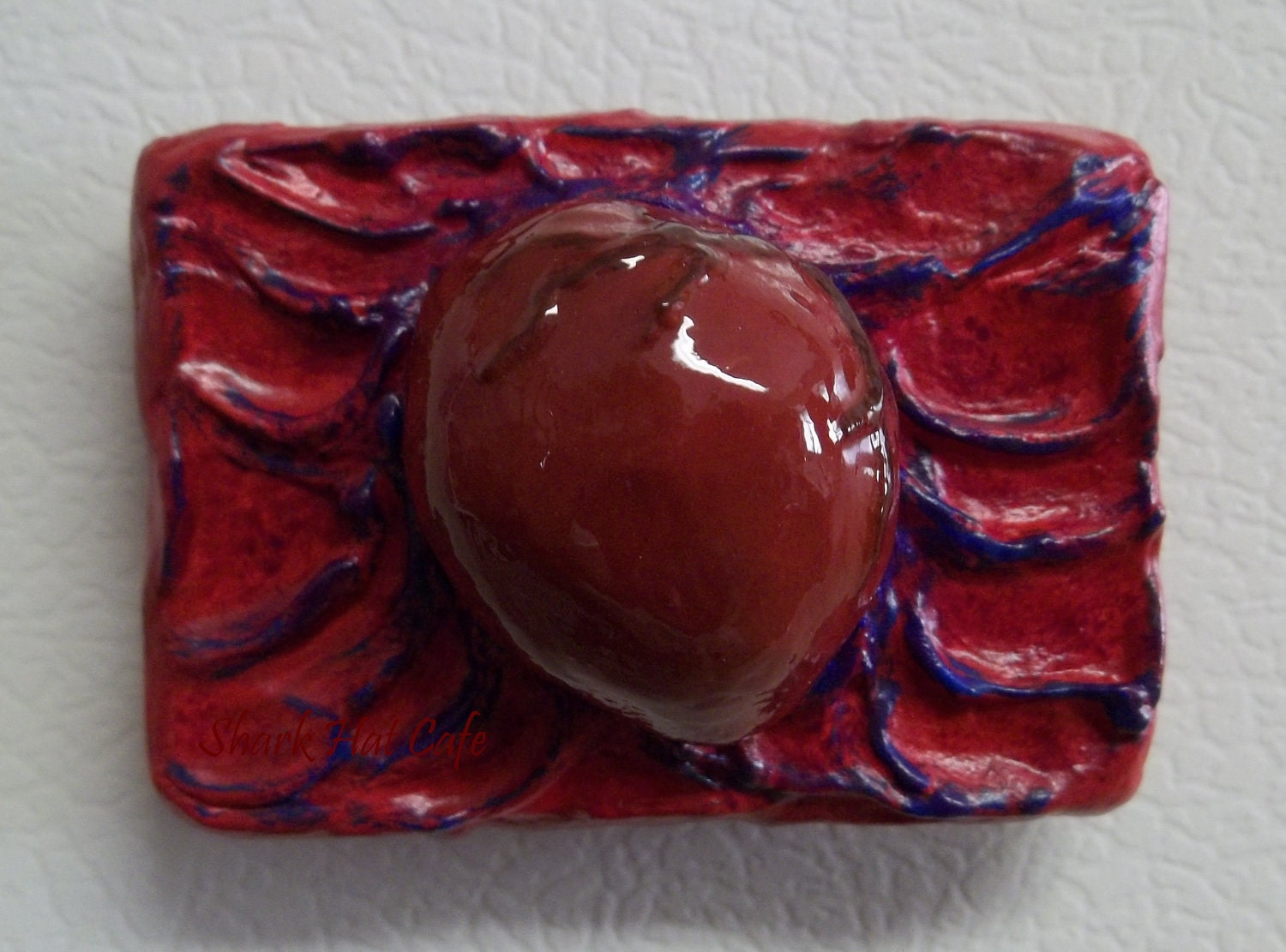 red heart on red, purple, and blue background magnet