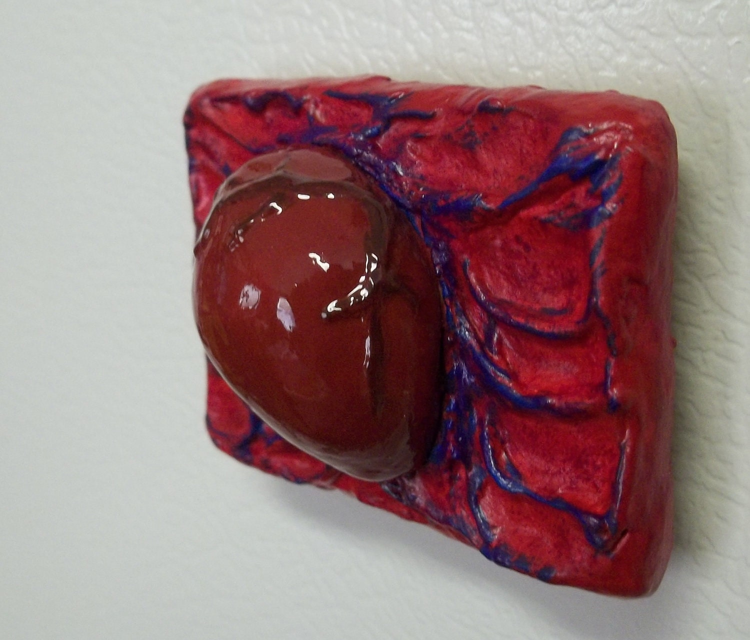 red heart on red, purple, and blue background magnet