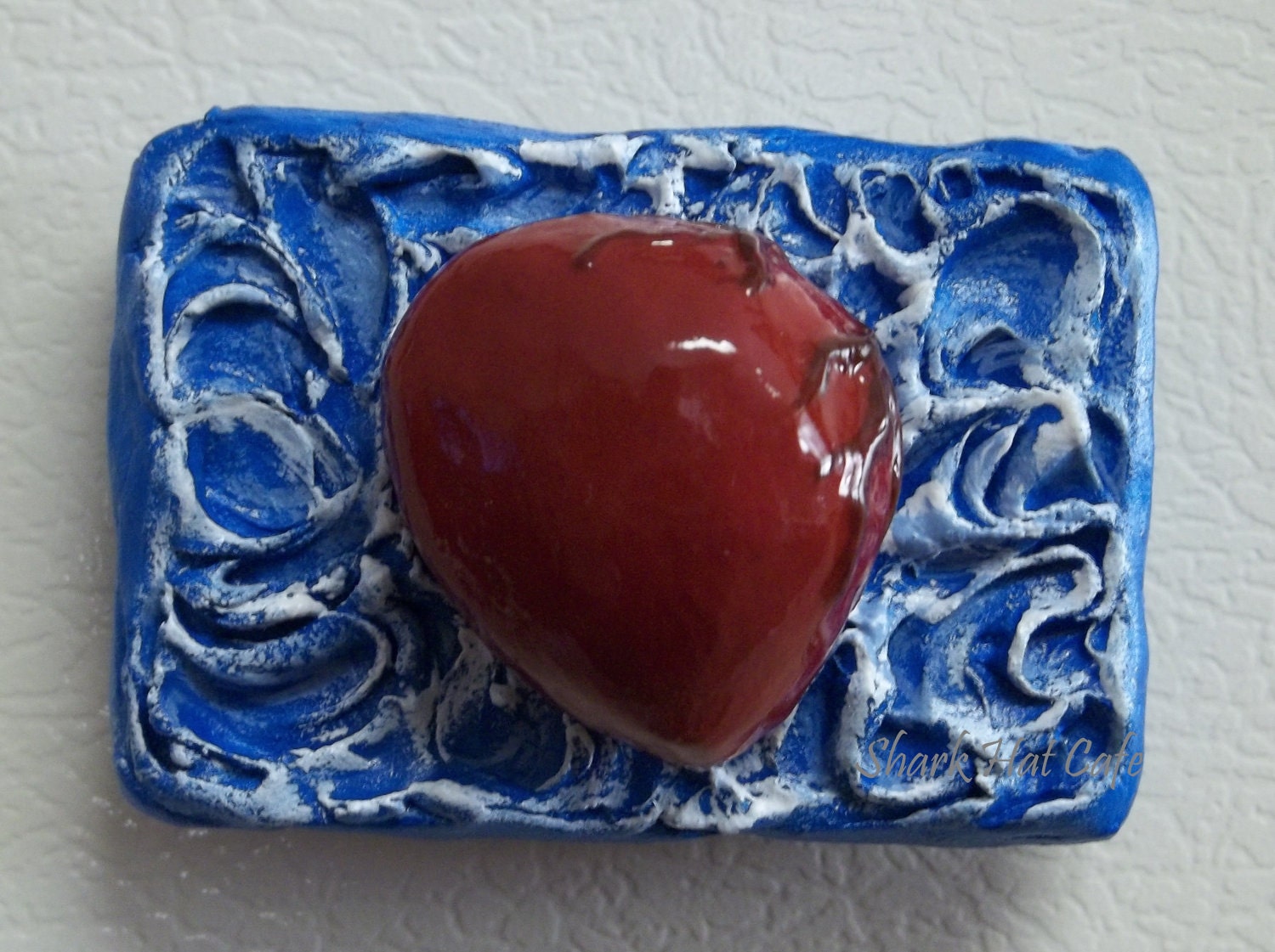 red heart on blue and white background magnet