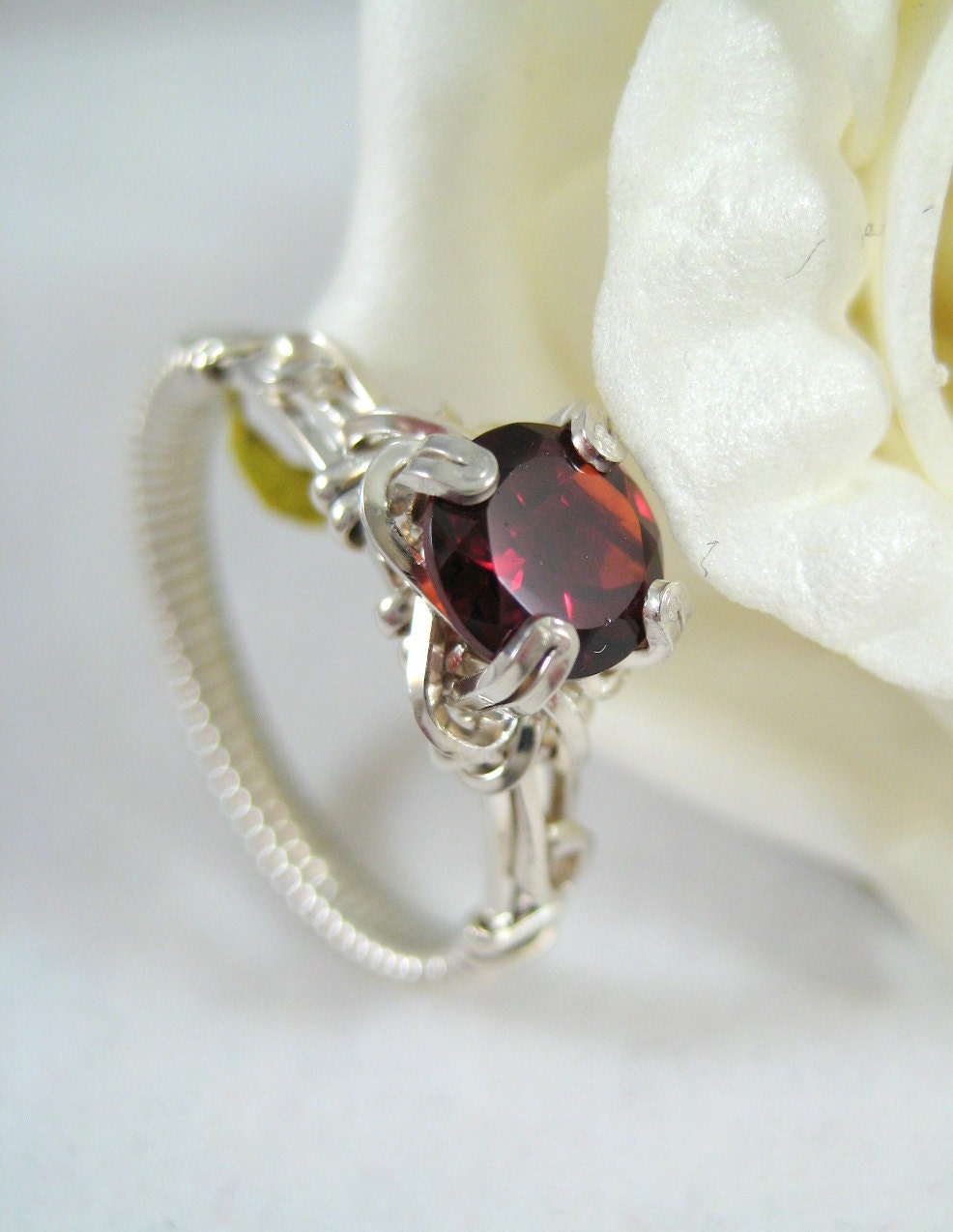 Garnet solitaire wire wrapped ring in argentium silver