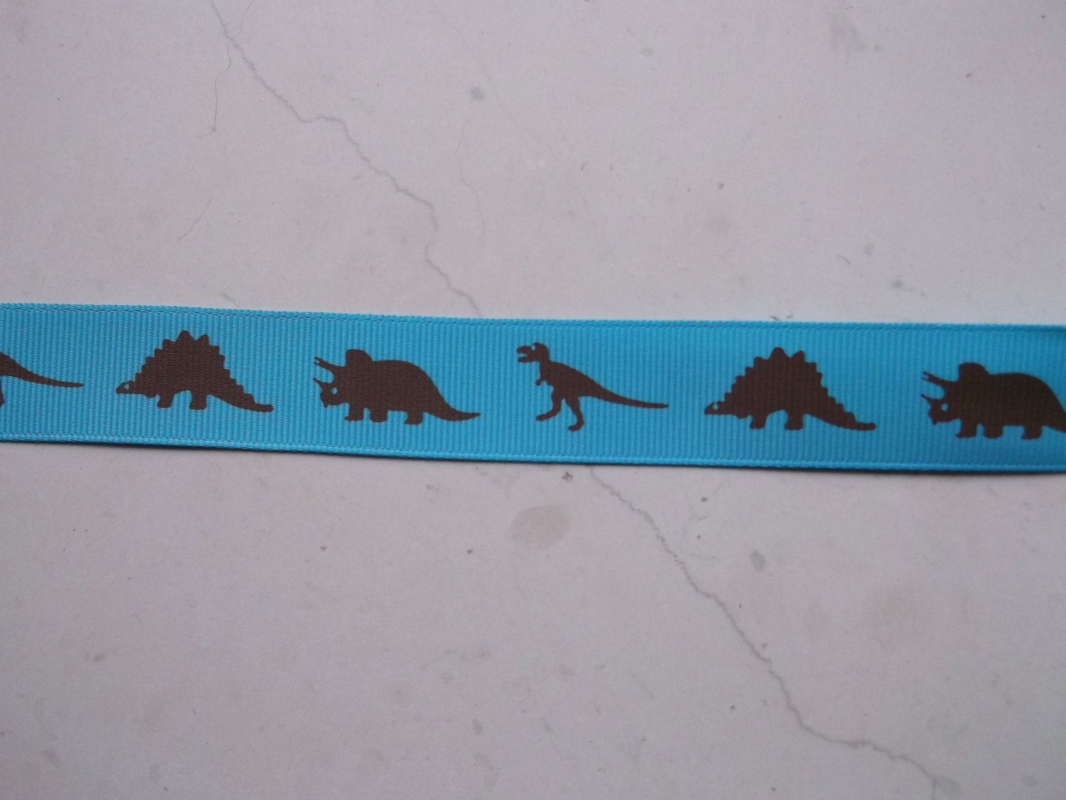 Brown Dinosaurs Silhouettes on turquoise 7/8 inch grosgrain ribbon Il_570xn