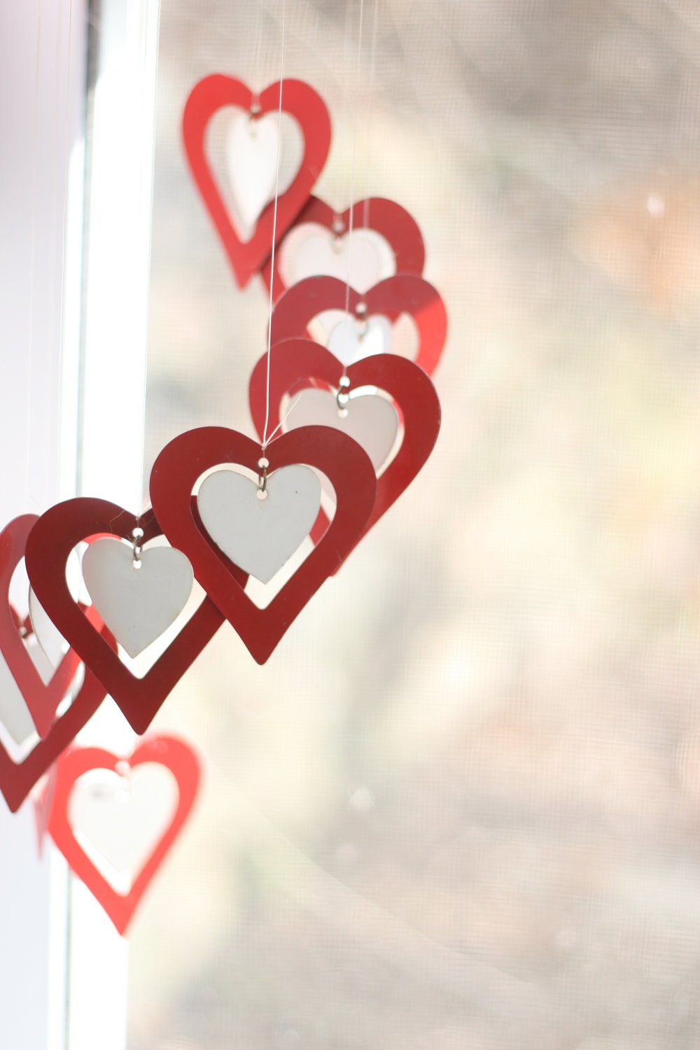 Hearts wind chime, brilliant red with little white centers. Valentine's decoration.
