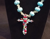 Multi stone cross on turquoise and peridot necklace