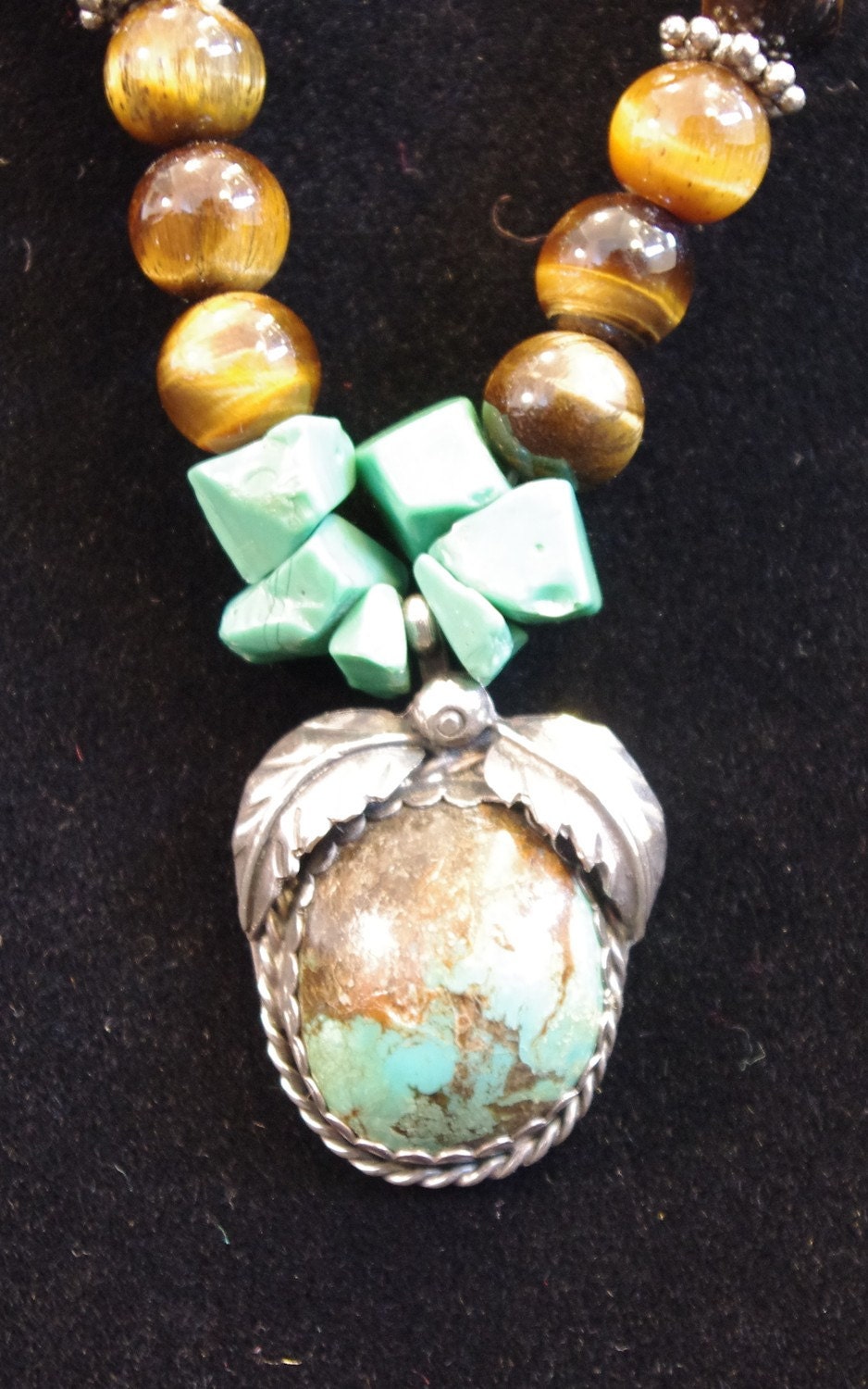 Turquoise and silver pendant signed by artist on neclace of turquoise and tigerseye