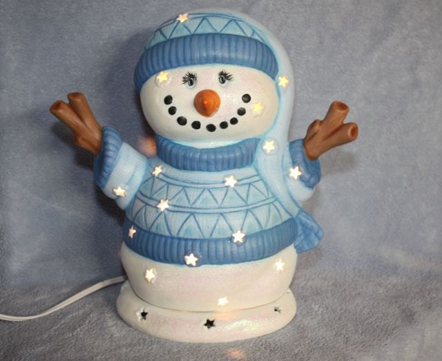 Handpainted Ceramic Star Lighted Snowman with a light blue sweater and matching snow hat