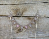 Its a girl cake Topper Banner in tea dyed cotton, white ,lowercase lettering, pink hearts, its a boy cake topper