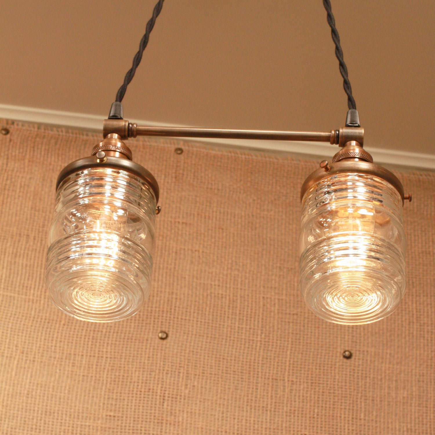 Chandelier Lighting with Twin Glass Shades and Antique Brass Spreader Bar and Black Twisted Wire