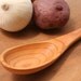 Curvy wooden spoon for stirring your sauce of salvaged plum wood