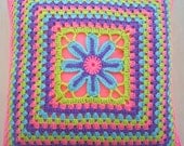 the flower in a granny square cushion cover / pillow