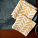Linen Cocktail Napkins - Four Feathers in Maize on Ivory Linen (set of 4)