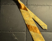 Golden necktie with woven flowers