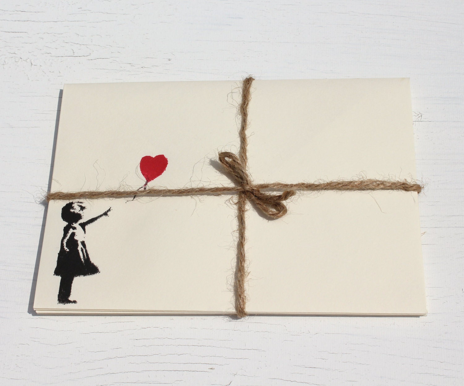 Five 5 ivory pastel envelopes, with red and black loveheart balloon girl on the front. Banksy style. cream stationary