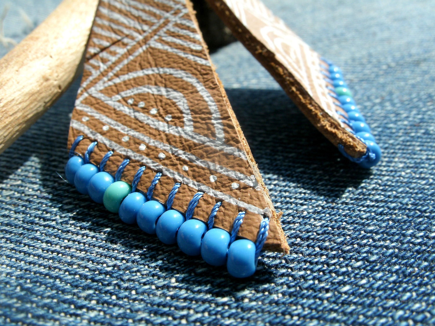 leather geometric earrings with  tribal Aztec design and blue beaded trim detail. handmade, one of a kind