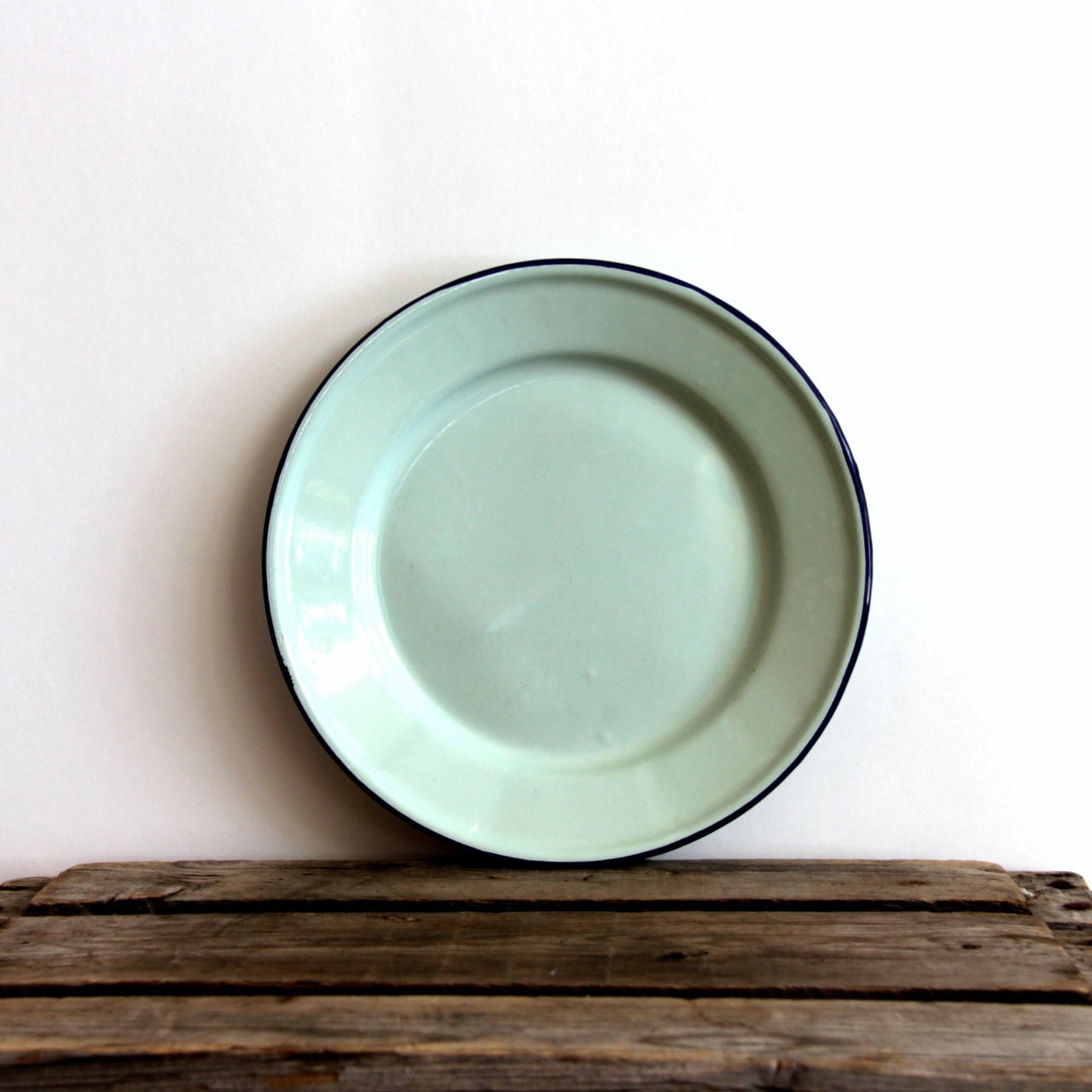 Mint green enamelware dinner plate with blue rim