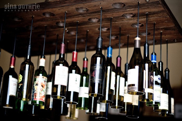 30 Wine Bottle Light Chandelier hanging from wood riddling rack
