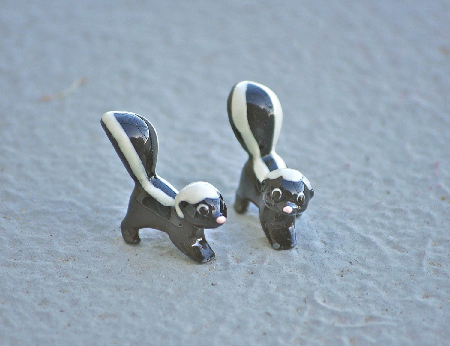 ceramic skunk figurines
