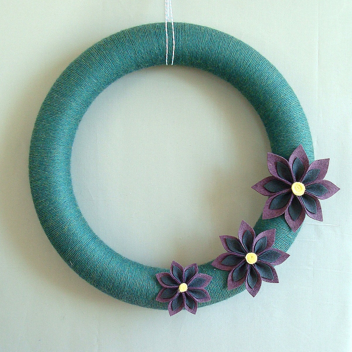 Teal Yarn Wreath. Summer Yarn wreath.  Teal, purple, charcoal and buttercup yellow. Felt lily flowers. 14 inch diameter.