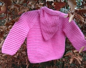 Little girl's pink jacket with a pixie hood.