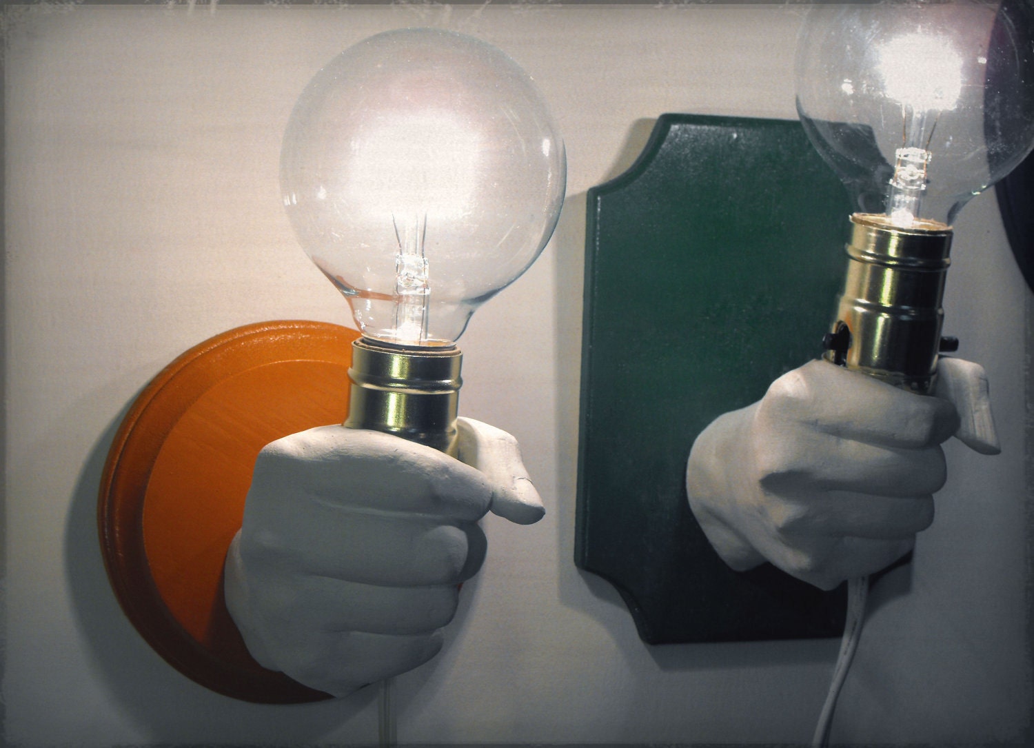 Hand Holding Bulb Wall Lamp (Orange)