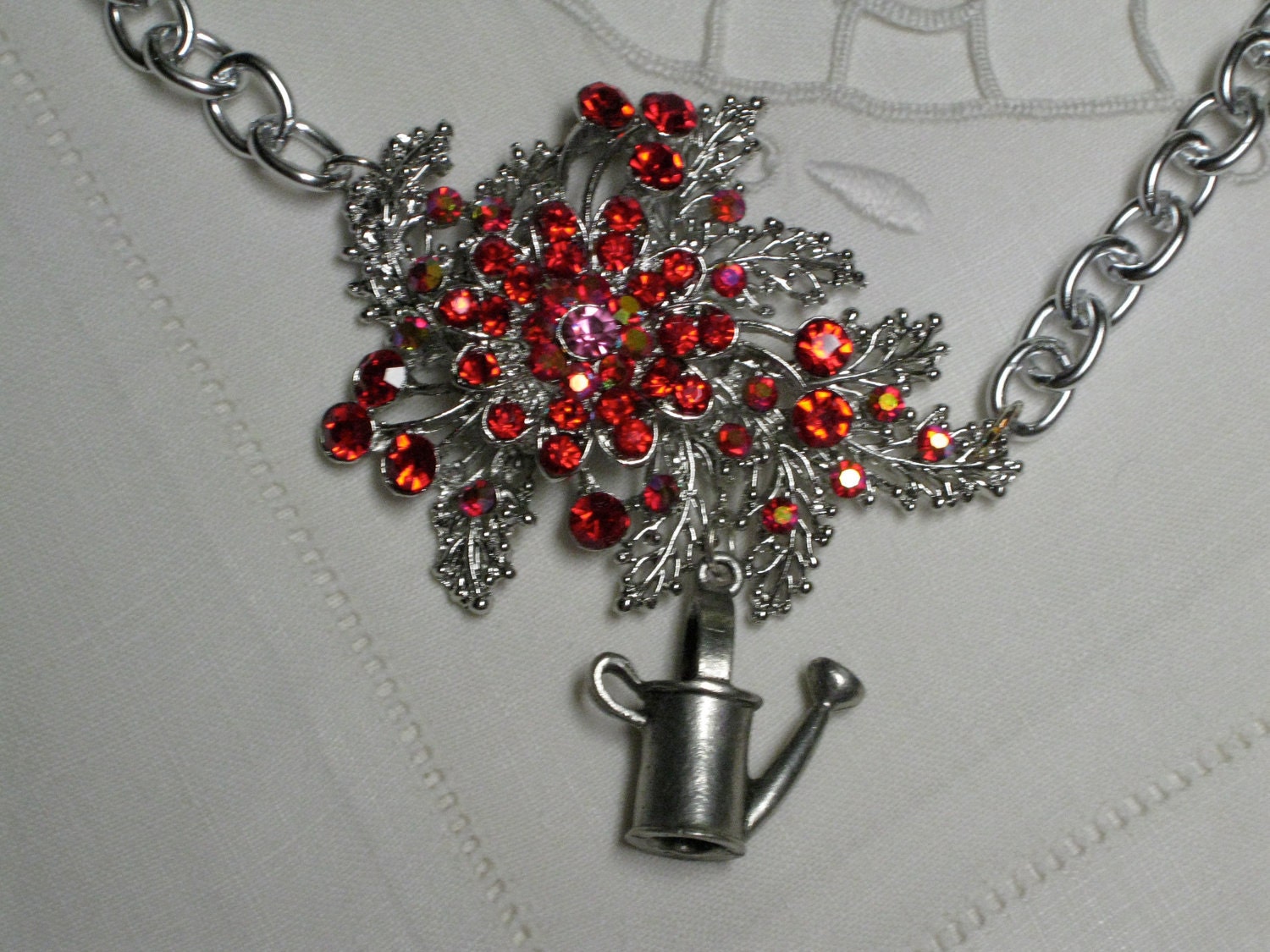Shimmering rhinestone flower brooch necklace with silver watering can