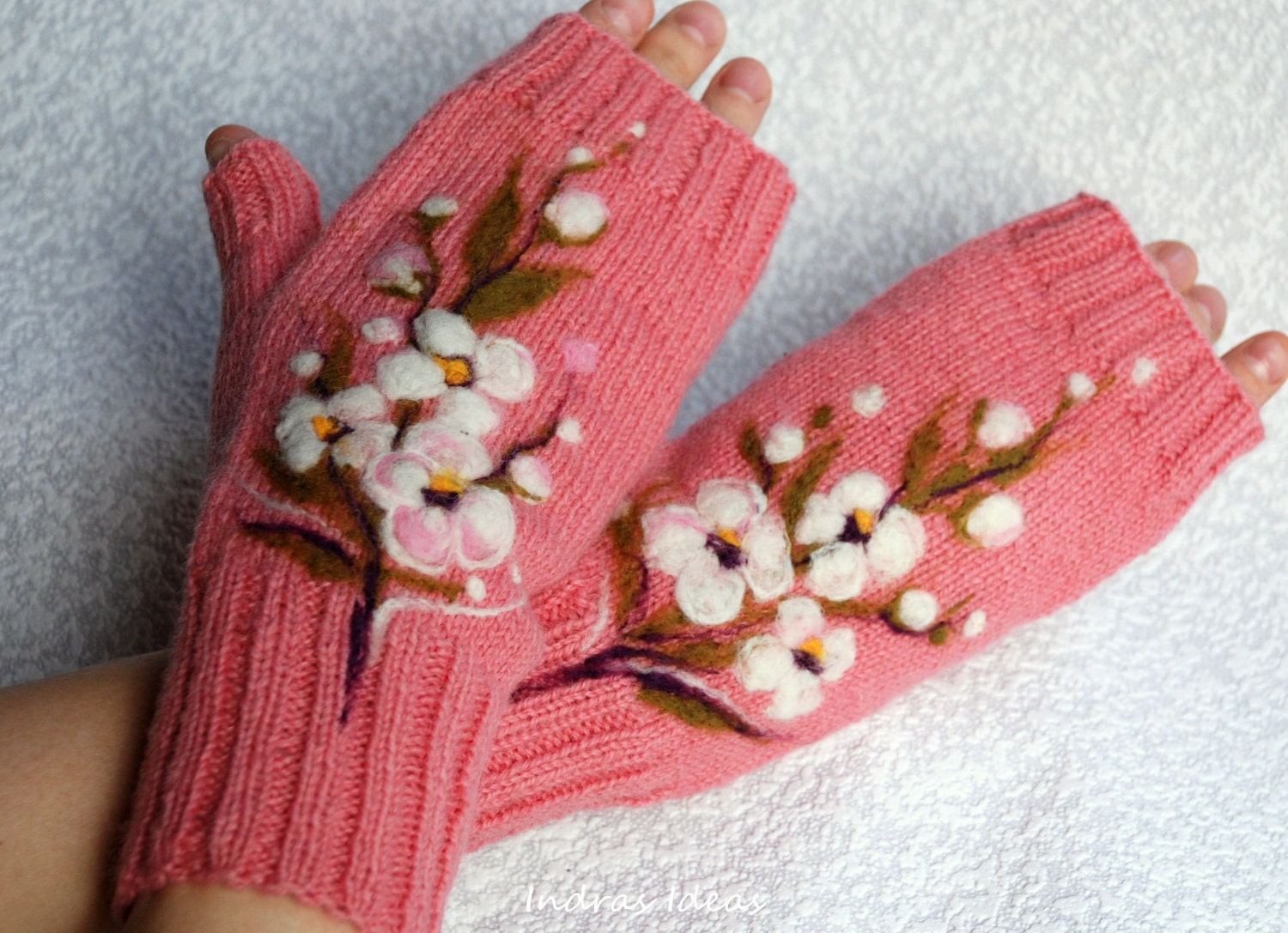 Pink fingerless gloves with felted flower.