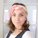 Use coupon code SAVE10 to receive 10% off knotted turban Headbands for women made of elastic fabric in marble cream and salmon color